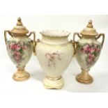 A pair of floral decorative porcelain urns 46cm tall together with a similar pattern vase.