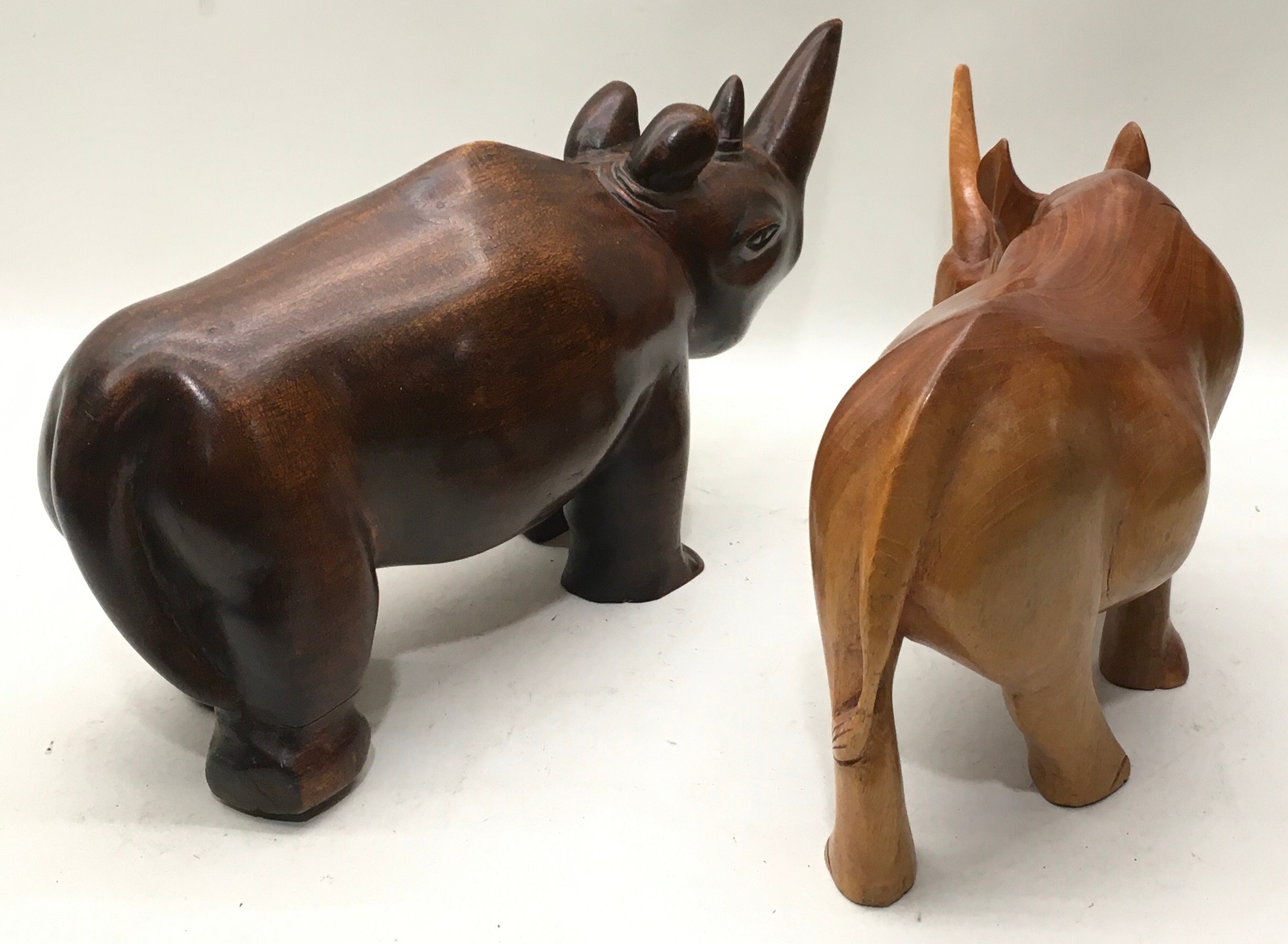 Pair of large solid wood carved rhinoceroses, the larger being 40cm across x 20cm tall - Image 3 of 3