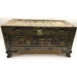 Small carved wooden chest featuring Oriental scenes to every side on raised claw feet. 68cm w x 32cm