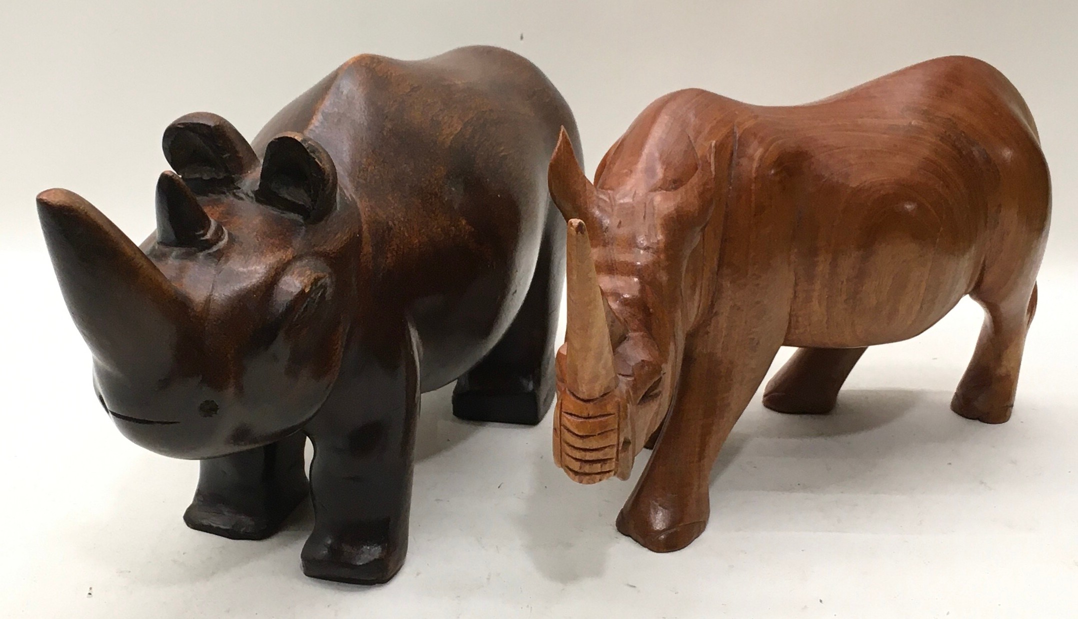 Pair of large solid wood carved rhinoceroses, the larger being 40cm across x 20cm tall - Image 2 of 3