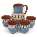Art studio pottery jug and 4 tumblers with slip decoration