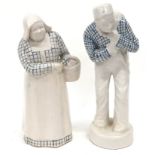 Pair of Royal Doulton early stoneware figurines. Man 23cm tall, lady 22cm tall.