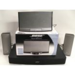 Bose Solo TV sound system with three speakers and a boxed Bose Sound dock. (W45)