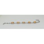 A silver and cabochon line bracelet