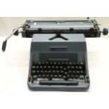 Vintage Imperial blue typewriter with cover.