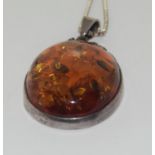 A large amber pendant necklace.