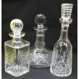 Three crystal glass decanters to include Waterford.