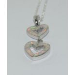 A silver and opal heart shaped drop pendant necklace