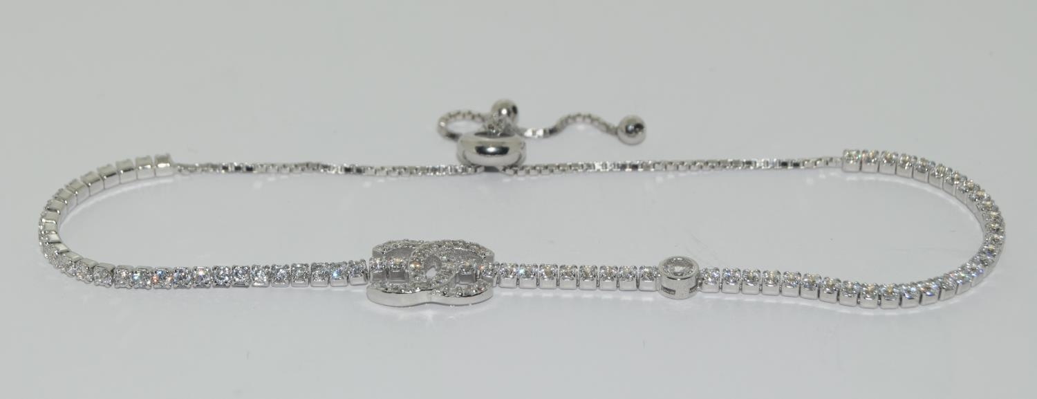 A silver & CZ designer style bracelet with size adjusters.