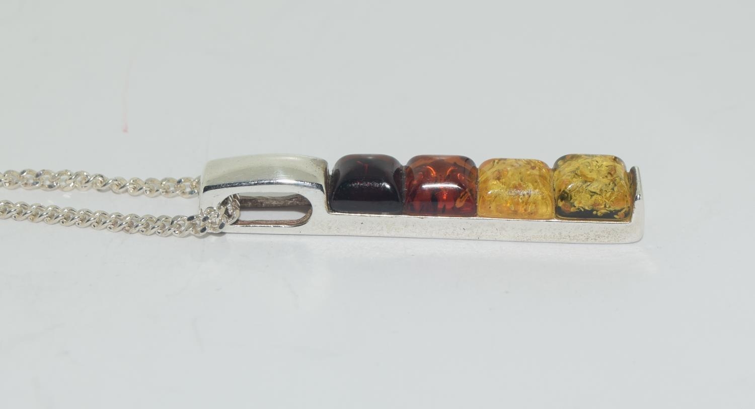 Multi coloured baltic amber 925 silver line pendant.