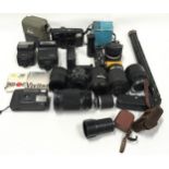 A box of assorted lenses and other camera accessories.