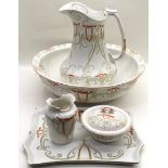 A five piece floral pottery wash set to include bowl, jug and soap dish.