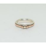 A silver and gold on silver knot ring fully hall marked, Size N 1/2.