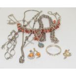 Collection of silver chains and bracelets.