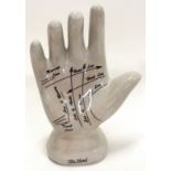 A ceramic palmistry hand.