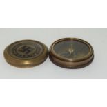 A brass compass with German inscription.