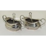 Pair of embossed silver twin handed salts and spoons 105gm Chester 1903