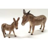 Two Beswick Donkey figures.