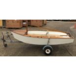 A 11ft x 4.5ft Mermaid dingy with trailer, oars and accessories.