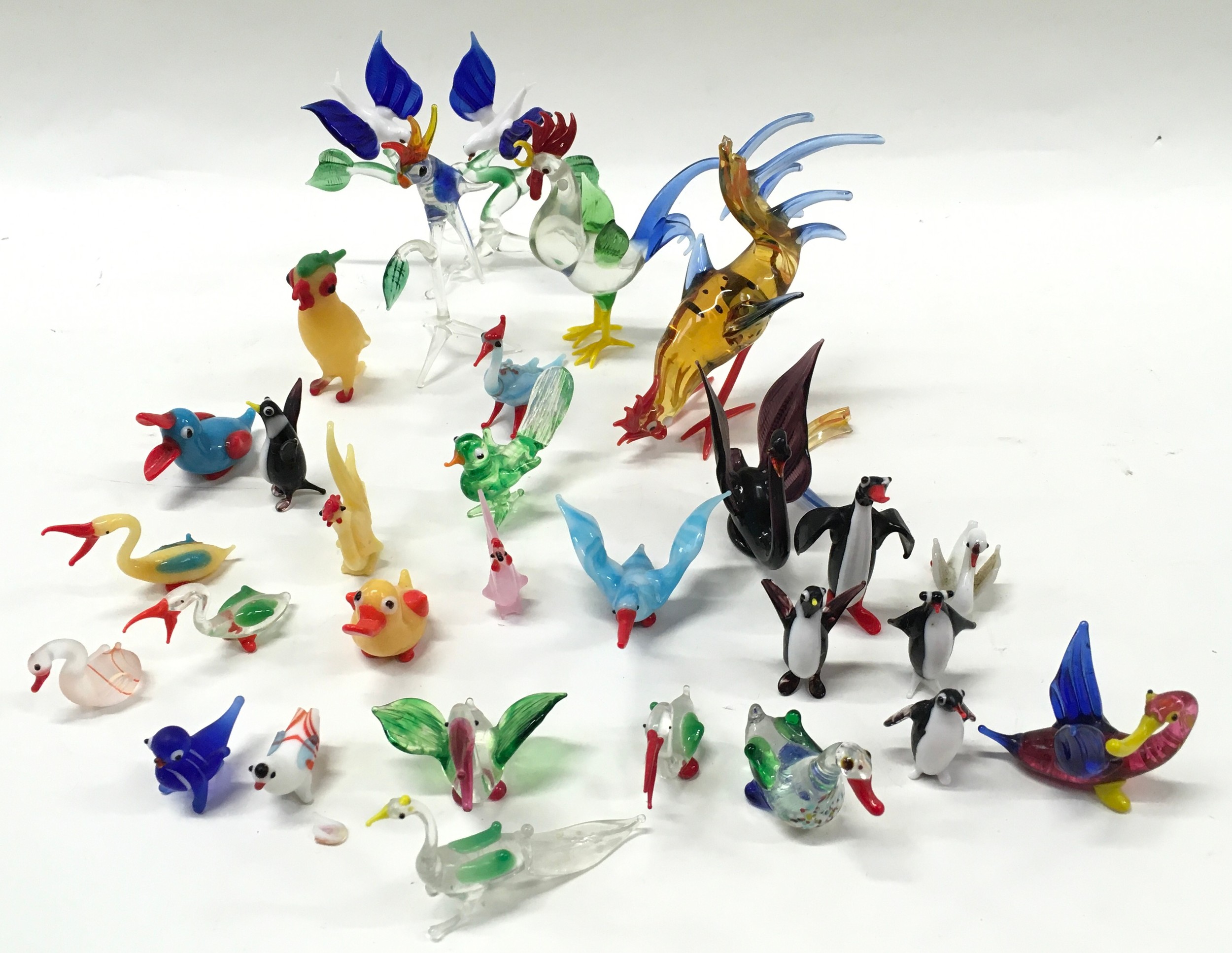 A collection of small Murano glass birds.