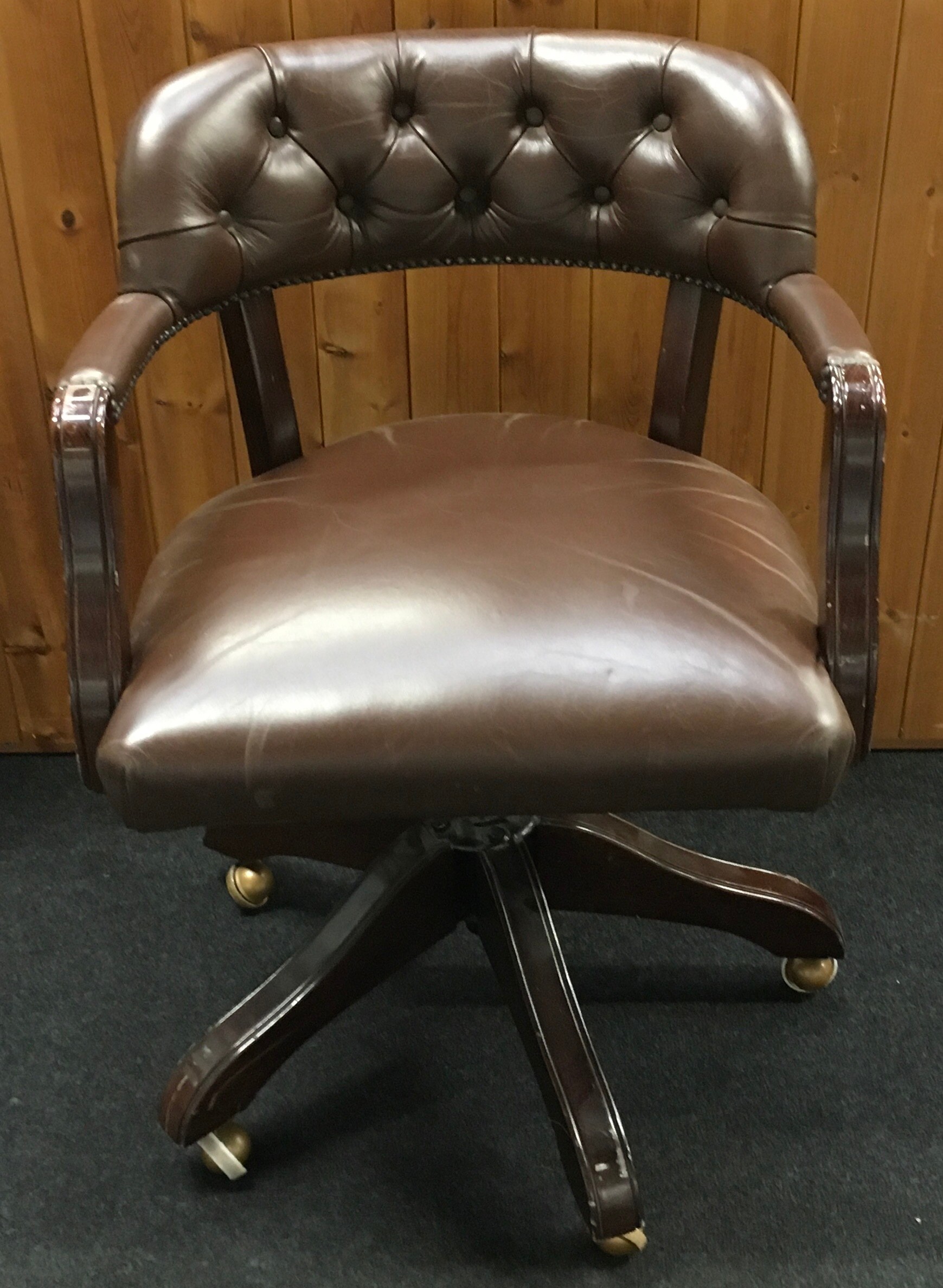 Button back captains office chair set on 5 splayed legs with castors with adjustable height levels