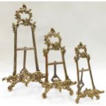 A set of three brass graduated easel back picture frame holders.
