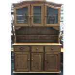 Pine two part dresser having 3 glassed upper cupboards over a 3 draw 3 cupboard base 190x130x40cm