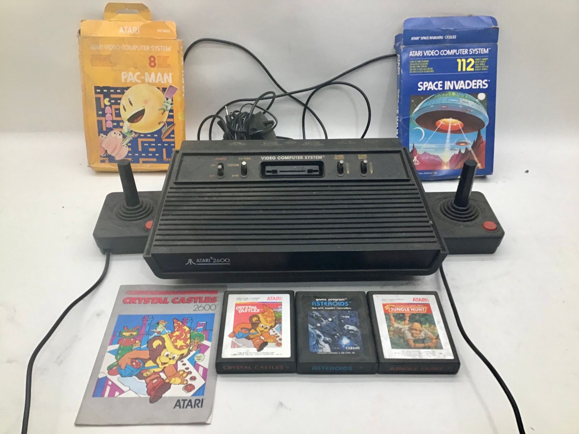 ATARI VIDEO GAME SYSTEM. This is model number 2600 and comes with power supply, 2 joysticks and 5