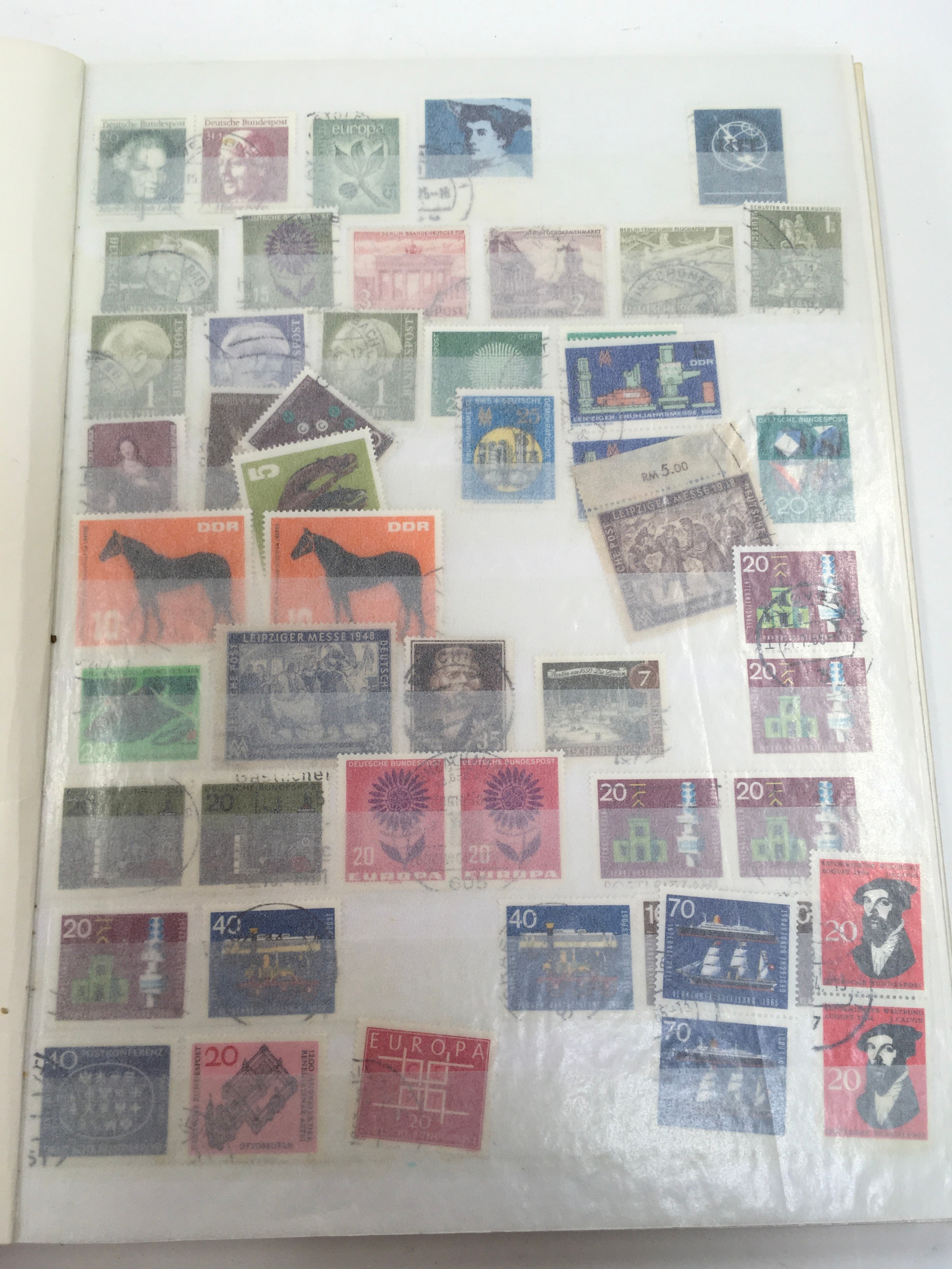 Red album containing German stamps.