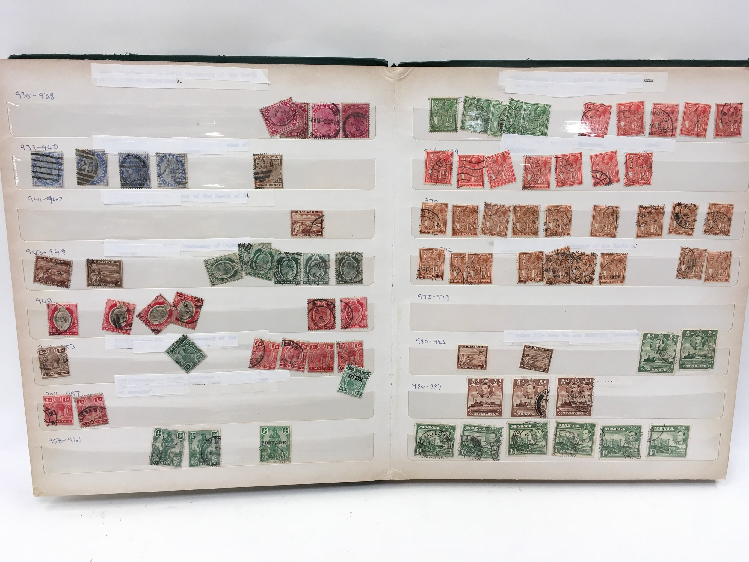 Green album containing Malta stamps.