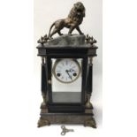 Large antique chiming marble and bevelled edge glass clock with lion figure to top. Includes key but