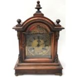 Antique French style wood cased chiming mantle clock with finials to top and ormolu mounts. Includes
