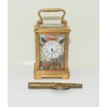 A brass cased miniature carriage clock with porcelain panels in the Crown Derby style.