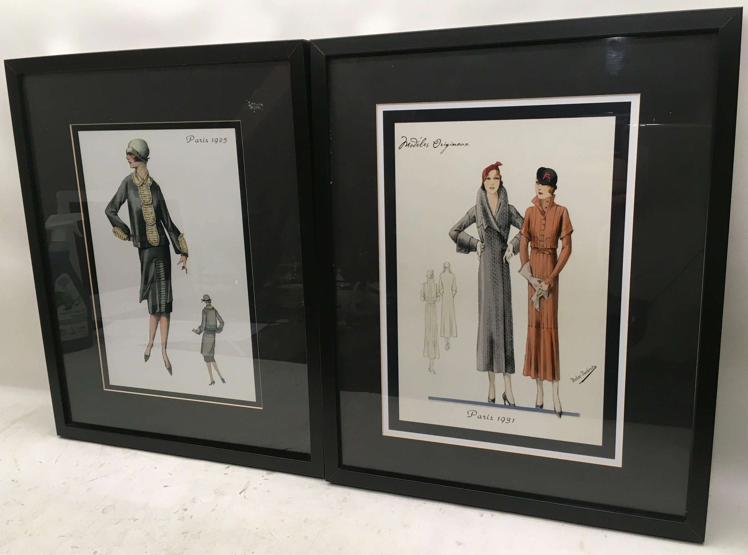 Pair of framed prints depicting early 20th century French fashion. Overall frame size 21" x 17"