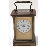 A Matthew Norman brass carriage clock with key.