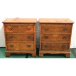 Pair of antique walnut veneer bedside tables of three drawers with brushing tables, featuring