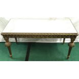Bevelled mirror topped coffee table with gilded swags and scrolls decorated frame on reeded