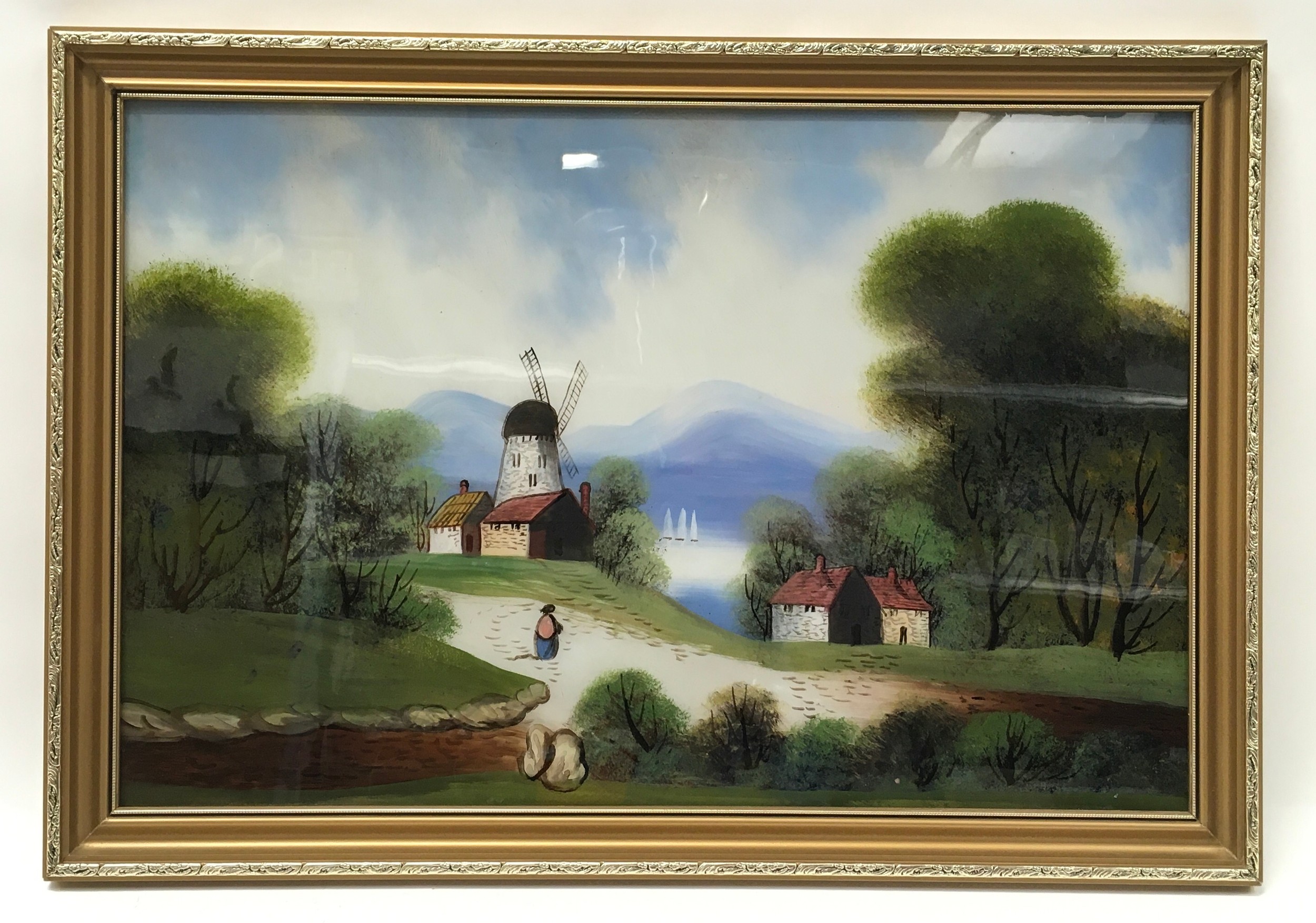 Gilt frame oil on glass depicting a lake side wind mill 65x45cm
