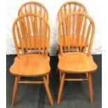 Set of four modern stick back dining chairs.