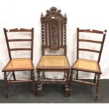 Carved oak hall chair with cane seat and barley twist supports together with a pair of cane seated