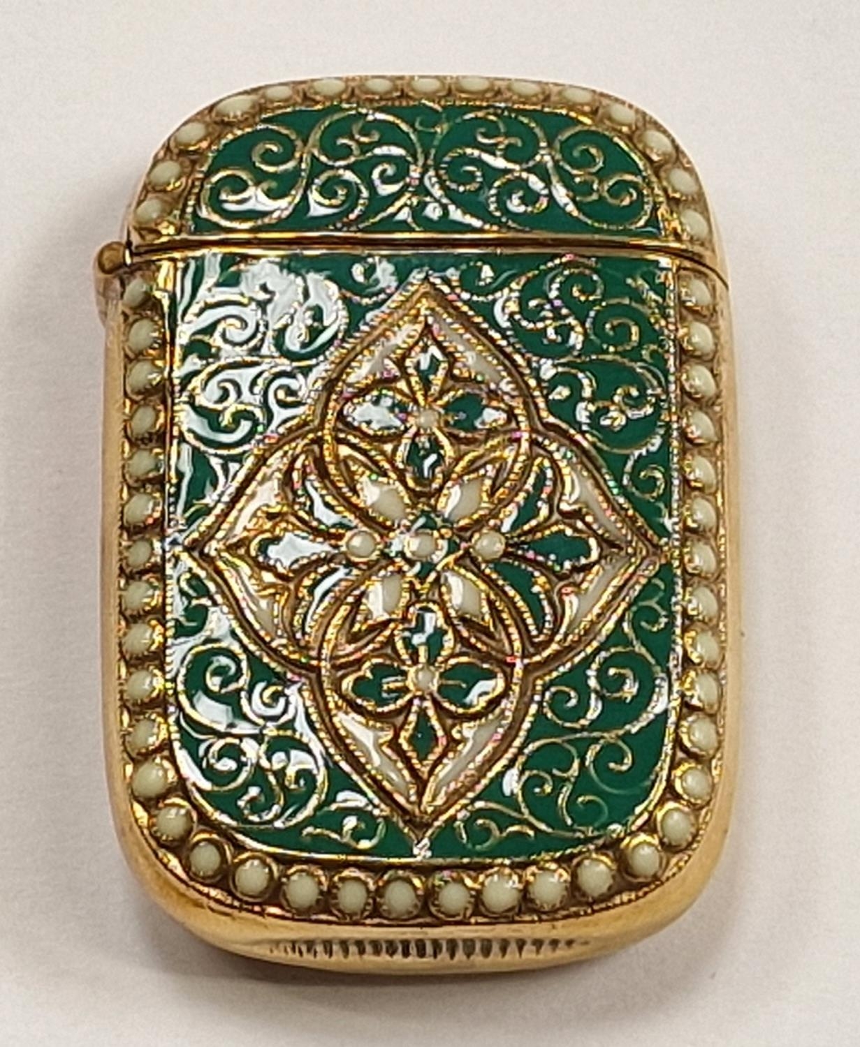 A brass cased Anderson style vesta with enamel decoration.