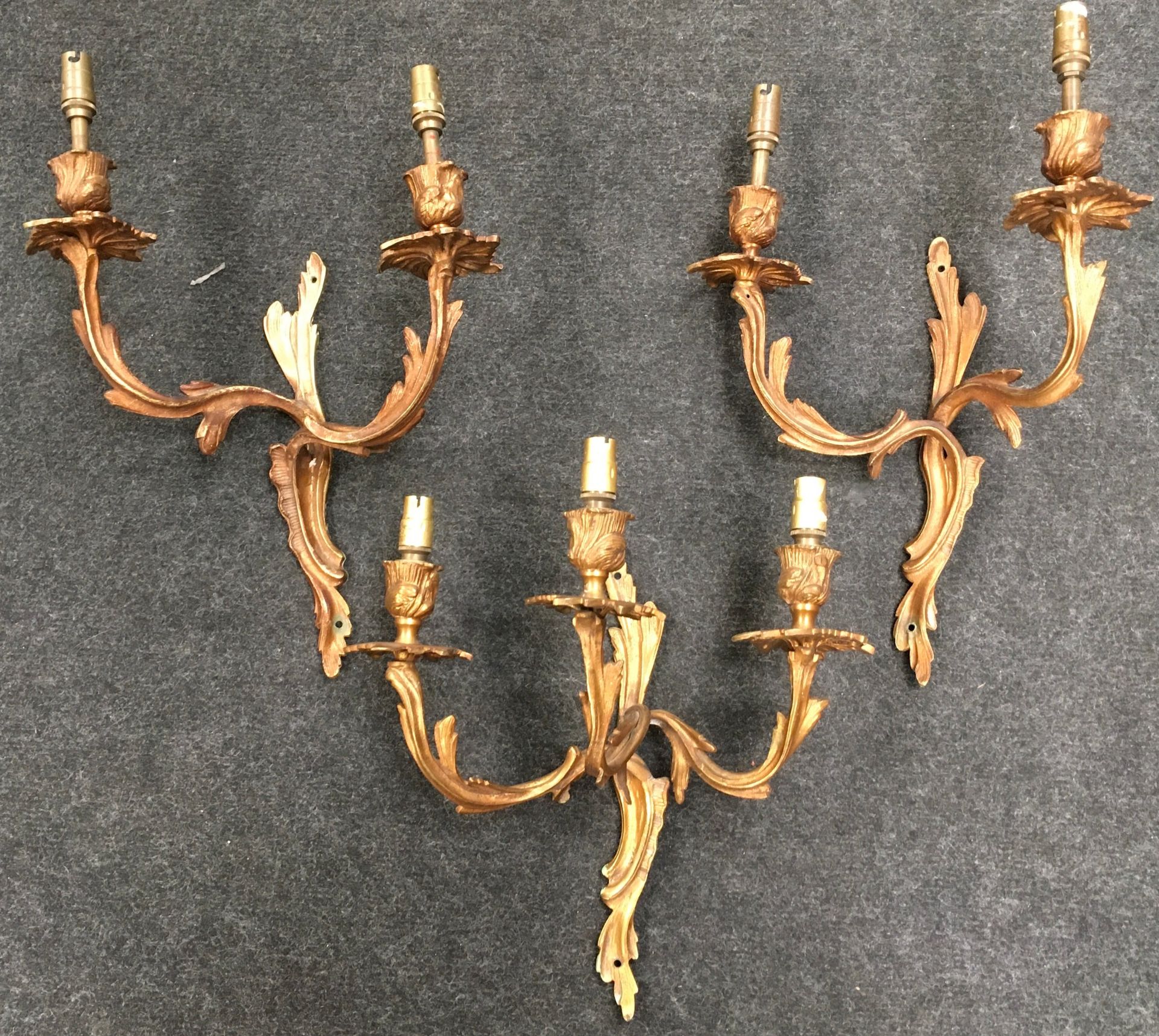 Three vintage brass wall lights with acanthus leaf decoration, 2 x two stem and 1 x three stem. Each