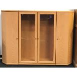 Tall siideboard with central glazed double door illuminated cupboard with additional shelved