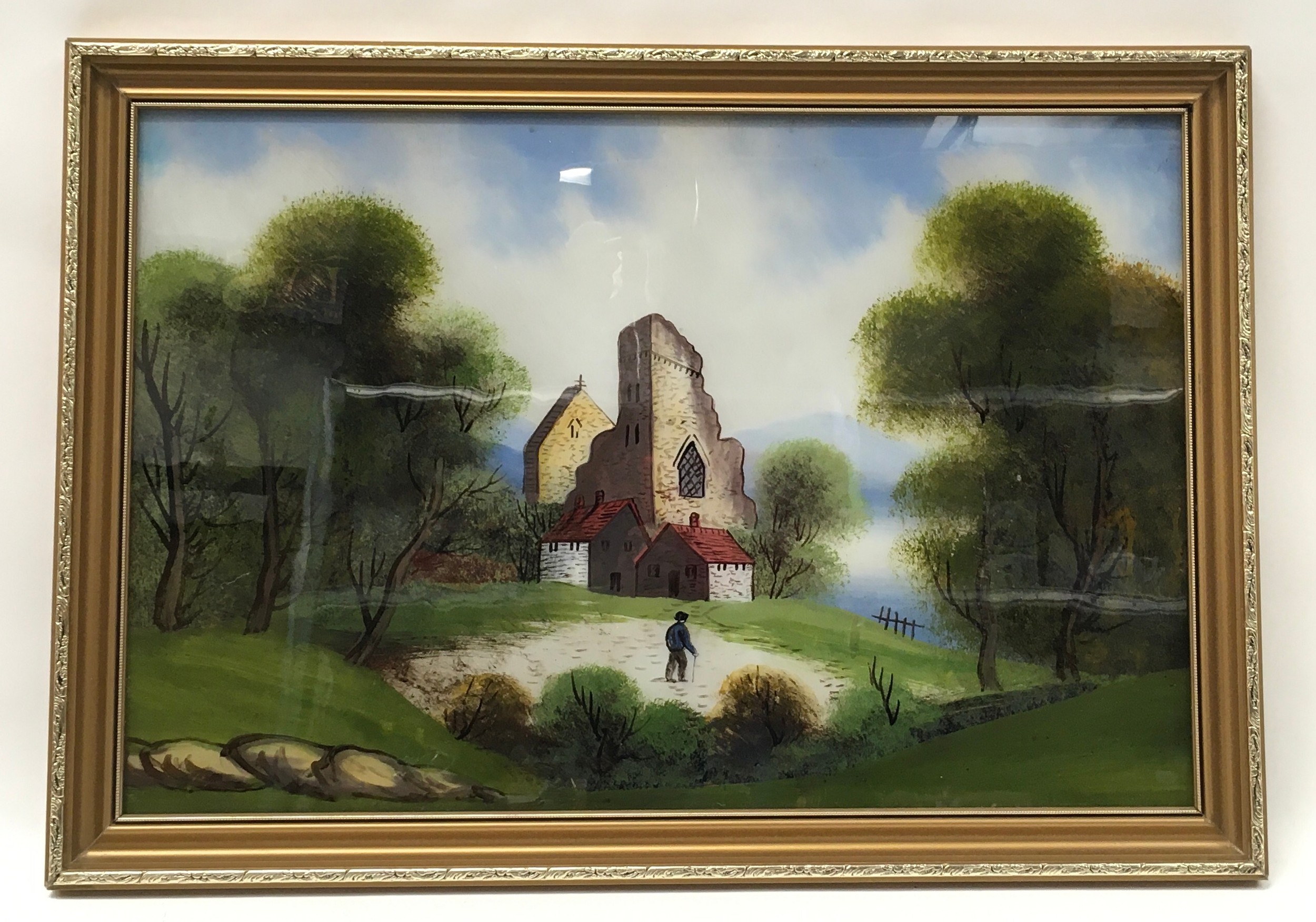 Gilt frame oil on glass depicting a vintage church scene 65x45cm