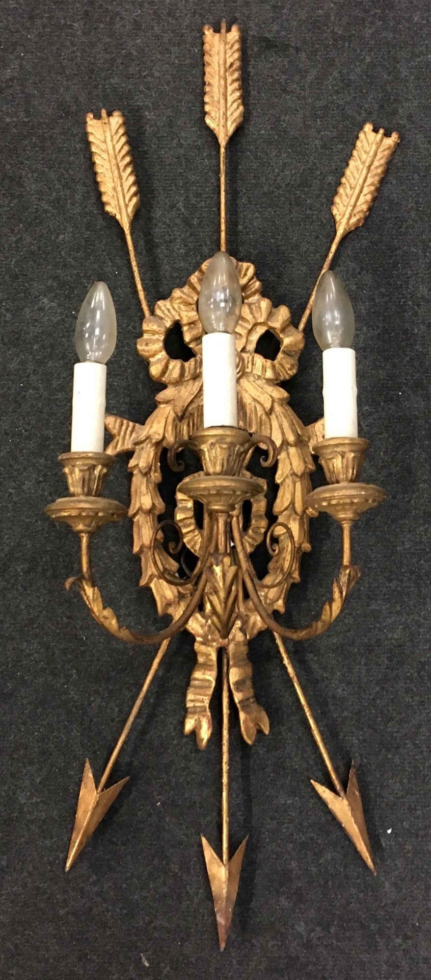 Unusual large 3 lamp wall light of gilded metal construction featuring fletched arrows and laurel