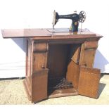 Vintage Singer Y7517563 sewing machine in oak wood cabinet 81x80x43cms.