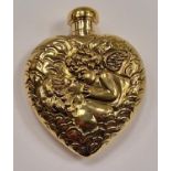 A brass perfume bottle with embossed decoration in the form of a heart.