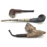 Three antique smoking pipes.