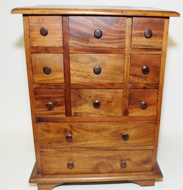 Small wooden curio's chest with eleven drawers. O/all size 41cm across x 54cm tall x 34cm deep