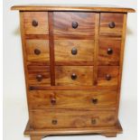 Small wooden curio's chest with eleven drawers. O/all size 41cm across x 54cm tall x 34cm deep